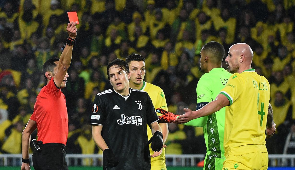 Wasit Jose Maria Sanchez (kiri) memberikan kartu merah kepada pemain Nantes Nicolas Pallois (kanan)  dalam laga leg kedua play-off babak Liga Europa 2022/2023 yang berlangsung di Stade de la Beaujoire, Jumat (24/2/2023). (AFP/Sebastien Salom-Gomis)