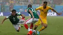 Di bawah guyuran hujan, laga Meksiko kontra Kamerun berlangsung cukup ketat. Tampak dua pemain Meksiko mencoba menghalangi pergerakan Eric-Maxim Choupo Moting (Kamerun - kiri) di Estadio das Dunas, Natal, Brasil, (13/6/2014). (REUTERS/Jorge Silva)