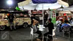 Pengunjung menunggu pesanan makanan yang dijual di atas mobil van di area Food Truck Convoy dalam ajang Indonesia International Motor Show (IIMS) 2015 di JIExpo Kemayoran, Jakarta, Selasa (25/8/2015). (Liputan6.com/Andrian M Tunay)