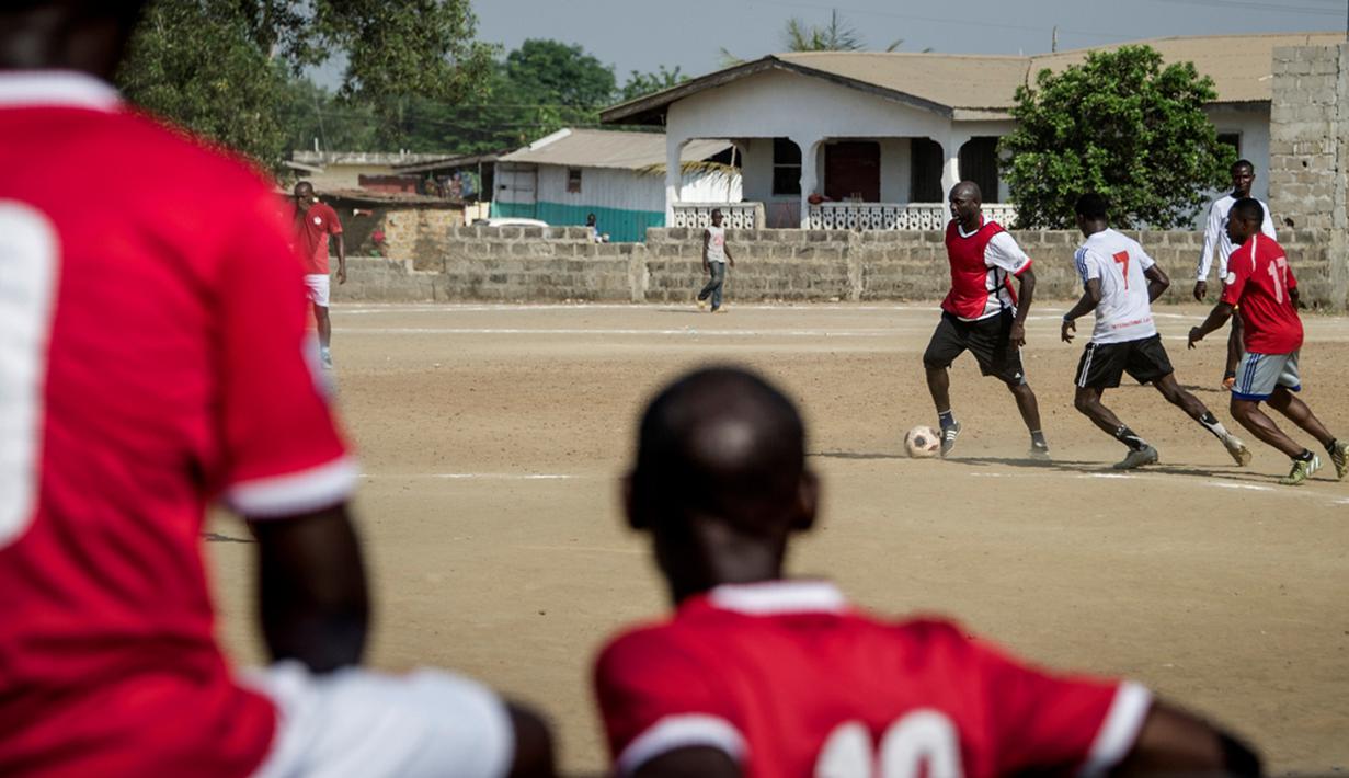 Pemain muda Liberia menonton saat mantan bintang Liberia, George Weah, bermain dalam sebuah pertandingan di Alpha Old Timers Sports Association di Monrovia, Liberia, (30/4/2016). (AFP/Marco Longari)