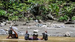 Peringatan ini menjadi momen penting bagi masyarakat setempat untuk merefleksikan kembali pentingnya menjaga sumber daya alam demi keberlangsungan generasi mendatang. Tampak dalam foto, orang-orang membawa pohon menyeberangi sungai untuk ditanam di jalur hutan dalam rangka memperingati Hari Bumi di Jantho, Provinsi Aceh, pada Rabu 22 April 2026. (CHAIDEER MAHYUDDIN/AFP)