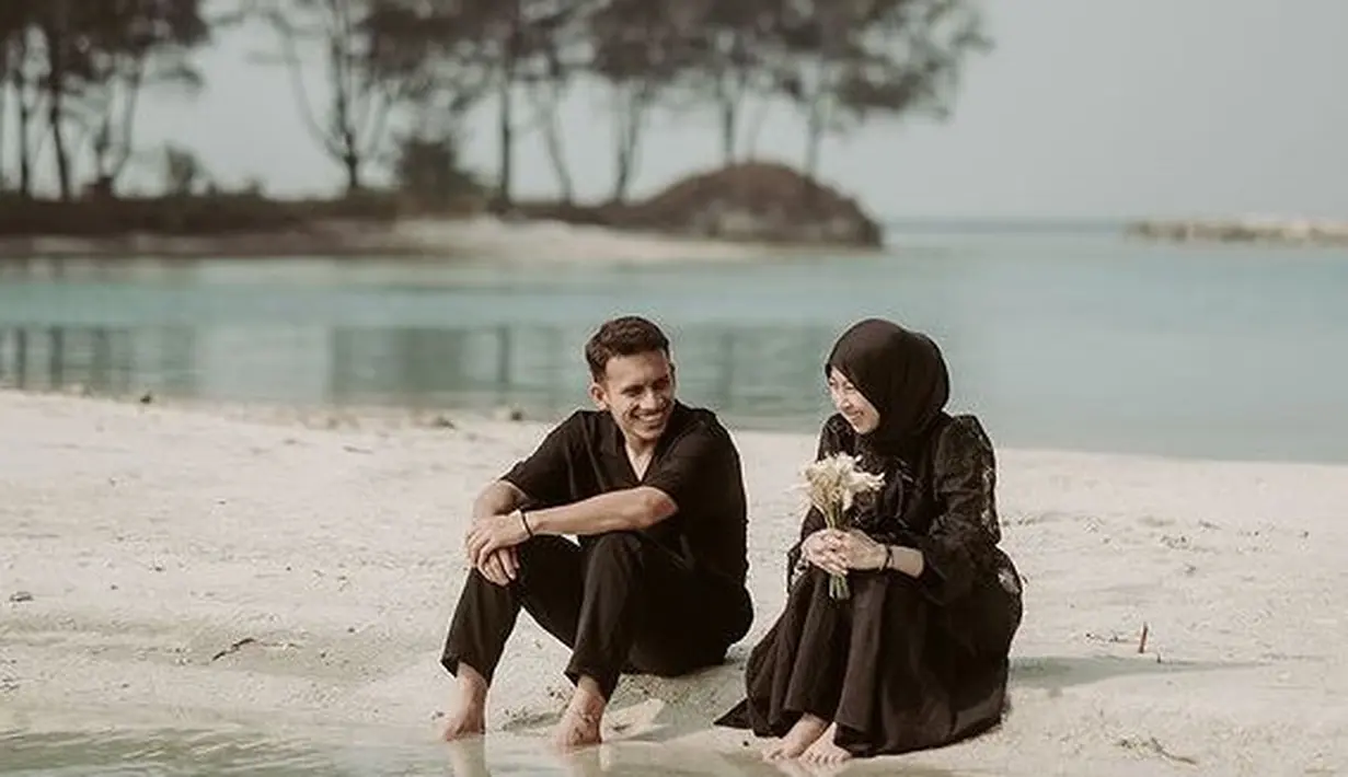 Adiba dan Egy Maulana yang baru saja menikah melakukan prewed dengan baju serba hitam di sebuah pantai. [@antzcreator]