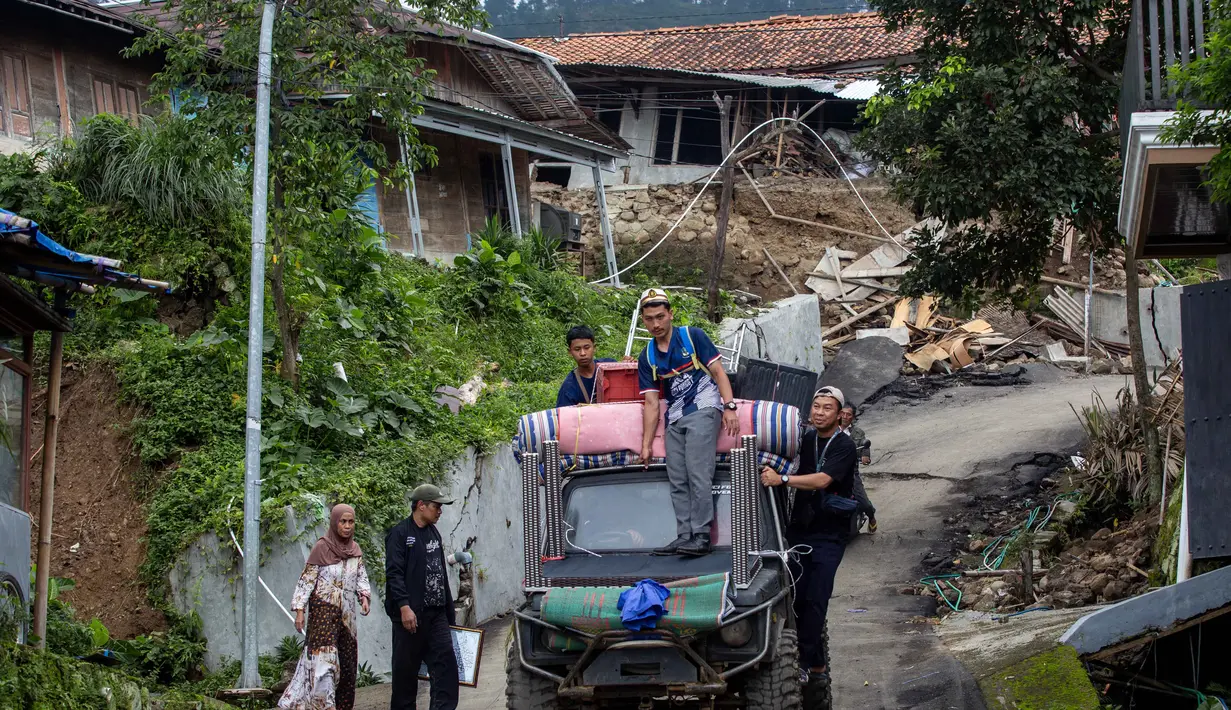 Pemerintah Kabupaten Tegal juga telah menetapkan status Tanggap Darurat Bencana Tanah Bergerak hingga 16 Februari 2026. Tampak dalam foto, warga menyelamatkan barang-barang mereka setelah pergerakan tanah melanda permukiman mereka di desa Padasari, Tegal, Jawa Tengah, Senin 9 Februari 2026. (DEVI RAHMAN/AFP)