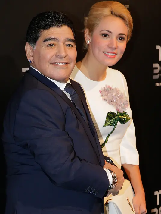 Diego Maradona bersama kekasihnya, Rocio Oliva berpose saat tiba menghadiri The Best FIFA Football Awards 2017 di London, Inggris (23/10). Rocio berusia 23 tahun  merupakan kekasih Maradona sejak lebih dari 3 tahun lalu. (AP Photo/Alastair Grant)