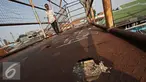 Pejalan kaki melintasi Jembatan Penyeberangan Orang (JPO) yang rusak di kawasan Tebet, Jakarta, Kamis (5/11). Kondisi jembatan yang sudah berkarat dan berlubang tersebut membahayakan pejalan kaki terutama saat malam hari. (Liputan6.com/Immanuel Antonius)
