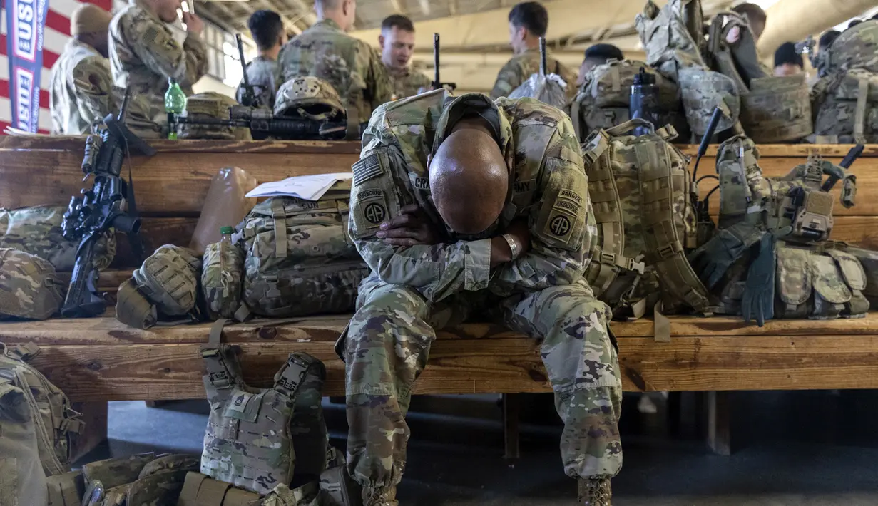 Seorang anggota Divisi Lintas Udara ke-82 Angkatan Darat AS bersantai menjelang penempatan ke Polandia dari Fort Bragg, North Carolina, AS, 14 Februari 2022. Mereka termasuk di antara tentara AS yang dikirim untuk NATO karena khawatir Rusia akan menyerang Ukraina. (AP Photo/Nathan Posner)