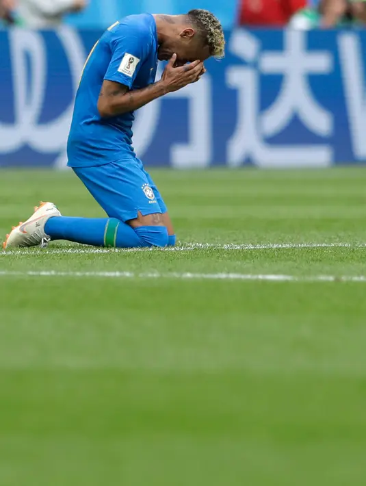 Penyerang timnas Brasil, Neymar berlutut di atas lapangan setelah mencetak gol ke gawang Kosta Rika pada pertandingan Grup E di St Petersburg, Rusia Jumat (22/6). Pada laga ini Neymar berhasil mencetak gol perdana di Piala Dunia 2018 (AP/Petr David Josek)