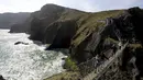 Sejumlah wisatawan mencoba melintasi jembatan Carrick-a-Rede Rope di Pantai Causeway, Irlandia Utara, Rabu (8/4/2015). Jembatan tersebut diperkirakan telah dibangun selama lebih dari 350 tahun oleh para nelayan salmon. (REUTERS/Cathal McNaughton)