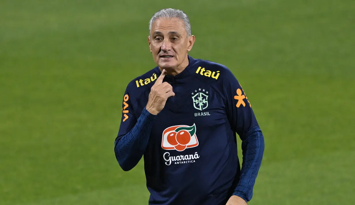 Pelatih Brasil, Tite menyaksikan pemainnya berlatih di Stadion Al Arabi SC di Doha (6/12/2022). Brasil akan bertanding melawan Kroasia pada babak perempatfinal Piala Dunia 2022 Qatar di Education City Stadium, Doha pada Jumat (9/12) pukul 22.00 WIB mendatang. (AFP/Nelson Almedia)