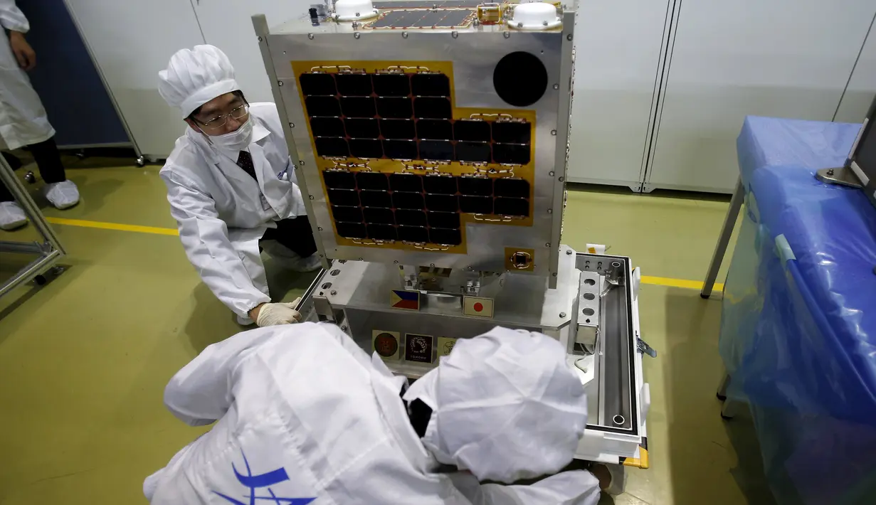 Staf dari Japan Aerospace Exploration Agency (JAXA) saat mempersiapkan Diwata - 1 di JAXA Tsukuba Space Center, Jepang, (13/1). Alat ini nantinya bermanfaat bagi bidang keamanan dan penanggulangan bencana. (REUTERS / Yuya Shino)