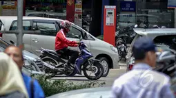Sejumlah kendaraan melintas di depan mesin parkir meter di Jalan Boulevard Raya, Kelapa Gading, Jakarta, Rabu (25/3/2015). Pembayaran parkir elektronik tersebut bertujuan untuk mempermudah masyarakat dalam melakukan transaksi. (Liputan6.com/Faizal Fanani)