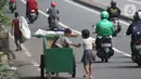 Pemulung melintas di Jalan Layang Prof DR Satrio, Jakarta, Kamis (30/4/2020). Setiap Ramadan tiba, kemunculan pemulung yang membawa gerobak marak terjadi. Saat ini, kemunculan mereka menjadi masalah tersendiri di tengah upaya memutus mata rantai penyebaran Covid-19. (Liputan6.com/Helmi Fithriansyah)