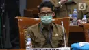 Menteri Pariwisata dan Ekonomi Kreatif Sandiaga Uno mengenakan masker saat Rapat Kerja dengan Komisi X di gedung DPR RI, Jakarta, Kamis (14/1/2021). Rapat dipimpin Ketua Komisi X Saiful Guda dari Fraksi PKB didampingi Hetifah Sjaifudian dari Fraksi Partai Golkar. (Liputan6.com/Angga Yuniar)