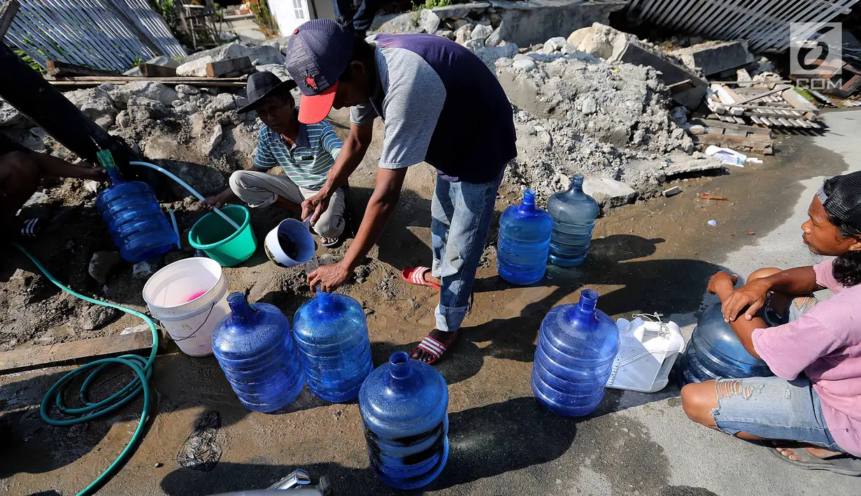Warga antre memanfaatkan air bersih dari kebocoran pipa PDAM di Jalan Lagarutu, Palu Sulawesi Tengah, Rabu (3/10). Pipa hitam berukuran besar keluar dari dalam tanah pasca gempa tsunami. (Liputan6.com/Fery Pradolo)