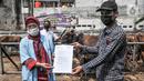 Tim dokter dari Sudin KPKP Jakarta Timur memberikan sertifikat kelayakan kepada pemilik usai memeriksa kesehatan hewan kurban di salah satu tempat penjualan di Jalan I Gusti Ngurah Rai, Jakarta, Kamis (15/7/2021). Pemeriksaan ini guna mencegah masuknya penyakit. (merdeka.com/Iqbal S. Nugroho)