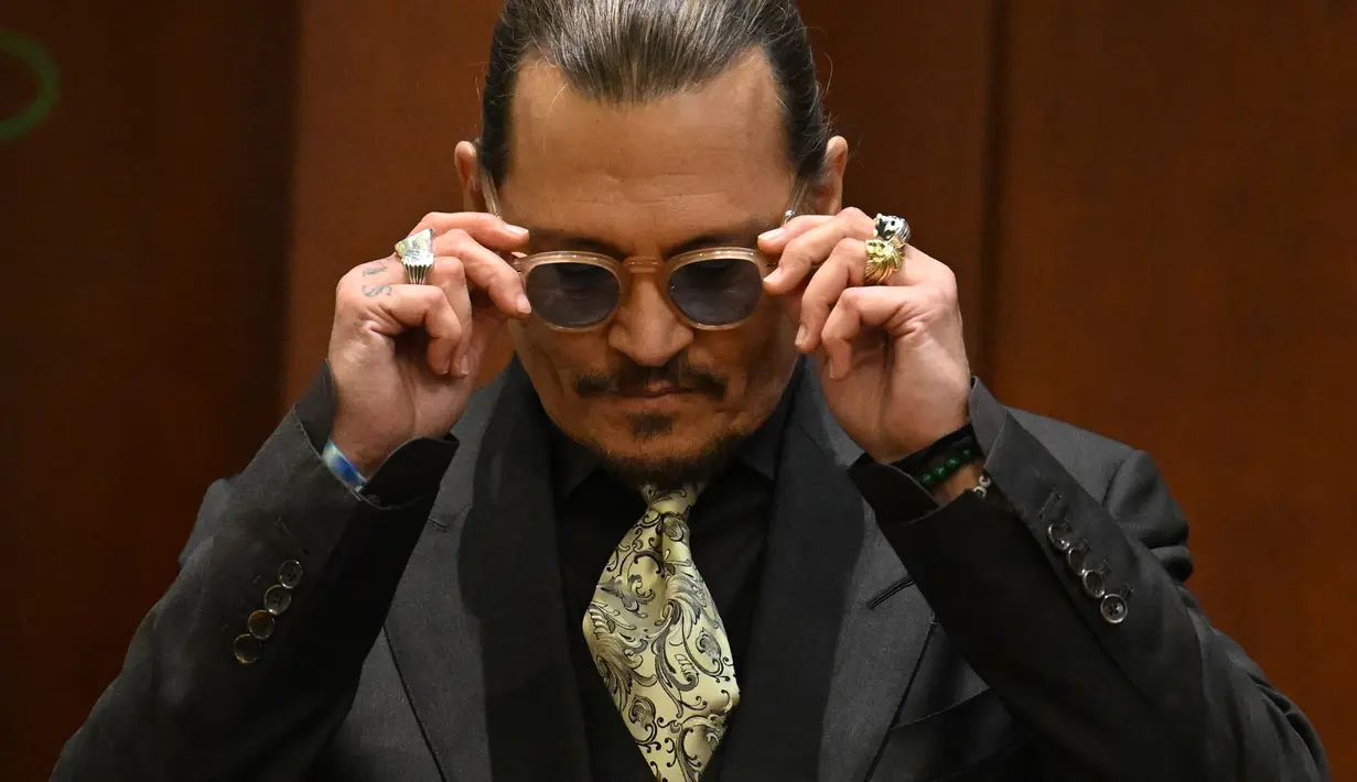 Aktor Johnny Depp bersaksi pada persidangan pencemaran nama baik di Fairfax County Circuit Courthouse, Fairfax, Virginia, Amerika Serikat, 19 April 2022. Johnny Depp menggugat mantan istrinya, Amber Heard, atas pencemaran nama baik. (JIM WATSON/POOL/AFP)