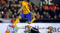 Striker Barcelona, Luis Suarez, melompati bek Valencia, Aymen Abdennour, pada laga La Liga di Mestalla, Valencia, Minggu (6/12/2015) dini hari WIB. (AFP/Jose Jordan)