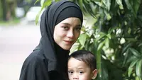 Lesti tampil kompak dengan sang anak dengan busana warna hitam. Ia pun mengenakan kerudung hitam dengan lipstik merah matte dan blush on warna pink. @rizkybillar