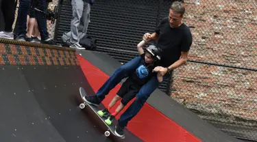 Legenda skateboard Tony Hawk bersama seorang anak Connor Curis meluncur dengan papan skateboard di Downtown Detroit (15/8). Taman skateboard ini  oleh Tony Hawk dan Ryan McGinness. (Tanya Moutzalias/Ann Arbor News-MLive.com Detroit via AP)