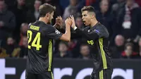 Striker Juventus, Cristiano Ronaldo, bersama Daniele Rugani melakukan selebrasi usai membobol gawang Ajax Amsterdam pada laga Liga Champions di Stadion Johan Cruyff, Rabu (10/4). Kedua tim bermain imbang 1-1. (AP/Martin Meissner)