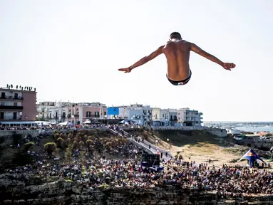  Atlet Meksiko, Jonathan Paredes, melakukan lompatan dari ketinggian 27 meter dalam kejuaraan loncat indah Red Bull Cliff Diving World Series di Polignano a Mare, Italia, (AFP/Dean Treml/Red Bull)