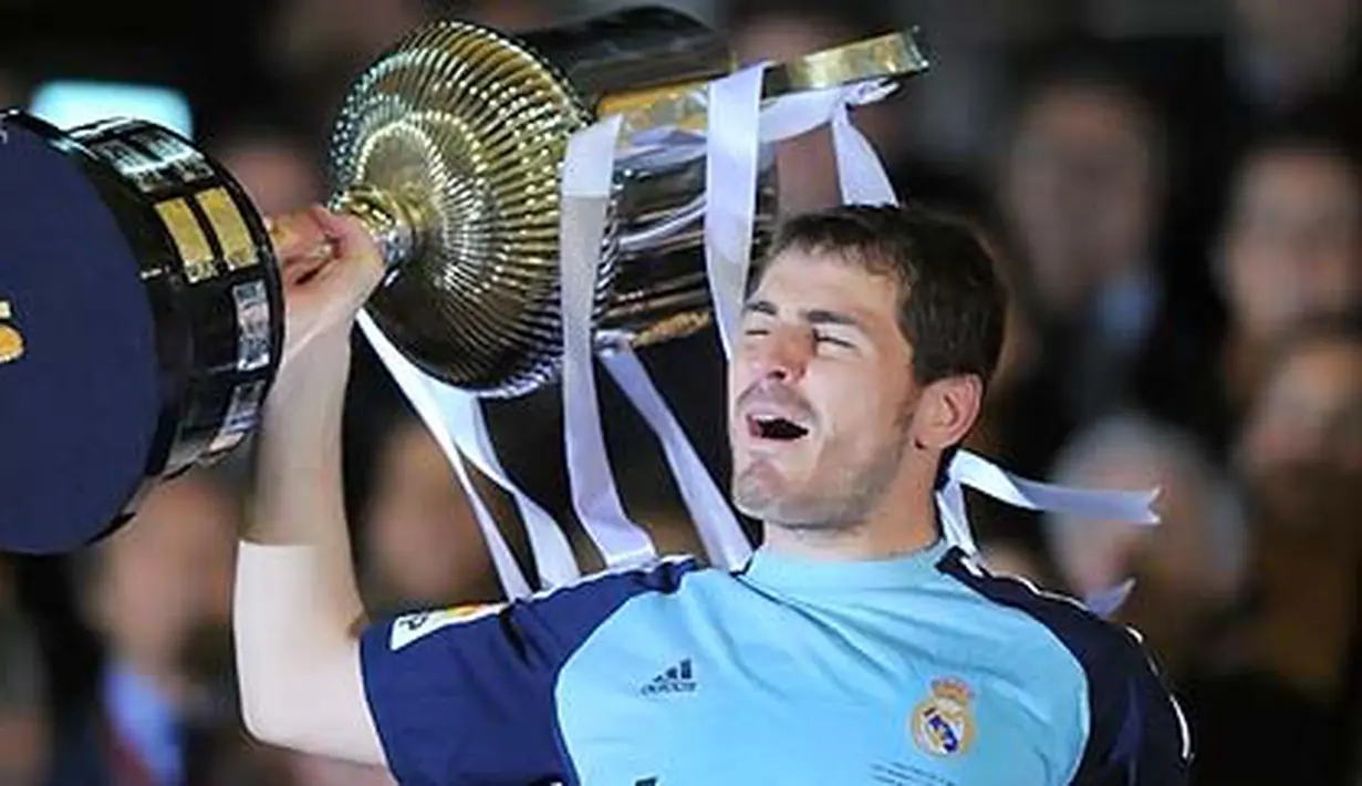 Kiper sekaligus kapten Real Madrid Iker Casillas mengangkat trofi Copa del Rey setelah menumbangkan Barcelona 1-0 dalam partai final di Estadio Mestalla, Valencia, 20 April 2011. AFP PHOTO/LLUIS GENE