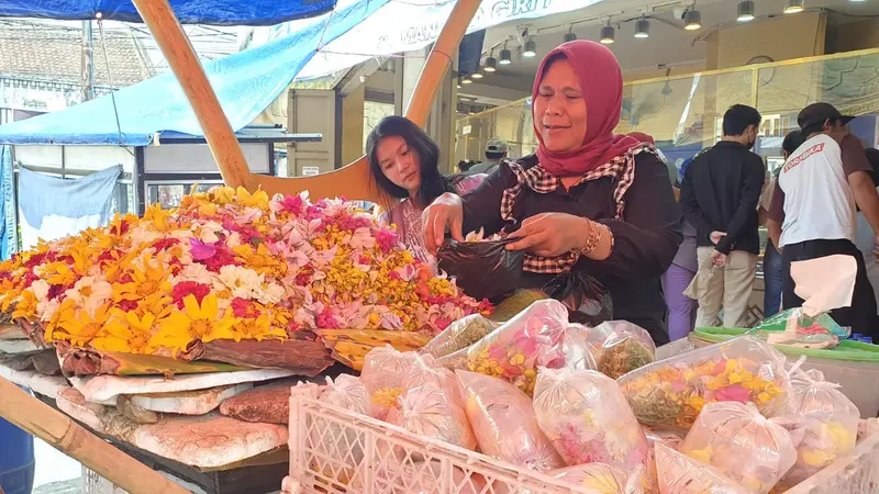 Dewi, salah satu penjual bunga rampes di Kawasan Pengkolan, Jalan A. Yani Garut, Jawa Barat tengah sibuk melayani pembeli.