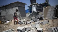 Seorang anak di Palestina melihat rumahnya yang hancur usai bentrokan Hamas dan Israel. Dok: AP Photo