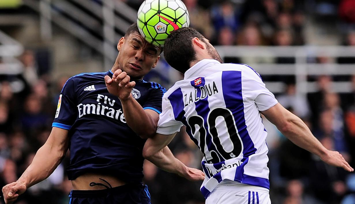Pemain Real Madrid, Casemiro (kiri), duel dengan pemain Real Sociedad, Joseba Zaldua, dalam laga La Liga Spanyol di Stadion Anoeta, Sabtu (30/4/2016) malam WIB. (AFP/Ander Gillenea)