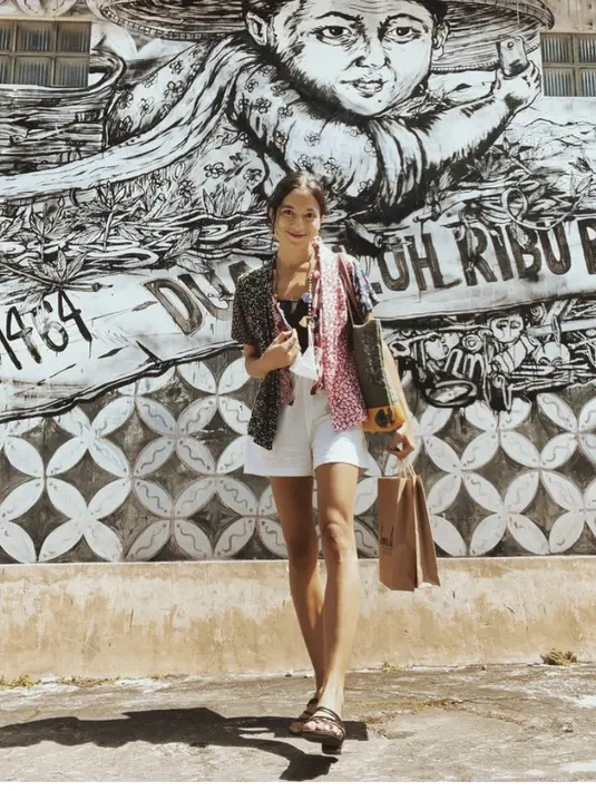 Putri Marino tampil dengan kebaya motif lengan pendek. Kebaya tersebut dipadukan dengan inner tank top hitam dan short pants putih.  (@putrimarino)