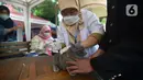 Paramedis menyuntikkan vaksin anti rabies kepada seekor kucing di Kecamatan Duren Sawit, Jakarta, Selasa (7/6/2022). Vaksin rabies yang diberikan secara gratis ini juag untuk mewujudkan Jakarta menjadi wilayah zona bebas rabies. (merdeka.com/Imam Buhori)