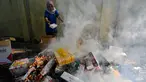 Petugas Bea dan Cukai membakar barang hasil penindakan berupa rokok impor ilegal saat pemusnahan di Banda Aceh, Aceh, Selasa (22/7/2025). (CHAIDEER MAHYUDDIN/AFP)