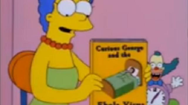 Istri Homer, yaitu Marge Simpson terlihat sedang memegang sebuah buku yang berjudul Curious George and the Ebola Virus (Capture/mental cornershop)