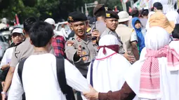 Polisi mengatur arus masuk massa aksi unjuk rasa di depan Kedubes AS, Jakarta, Minggu (10/12). Ribuan massa berkumpul memprotes keputusan Presiden Trump yang mengakui Yerusalem jadi Ibu Kota Israel. (Liputan6.com/Helmi Fithriansyah)