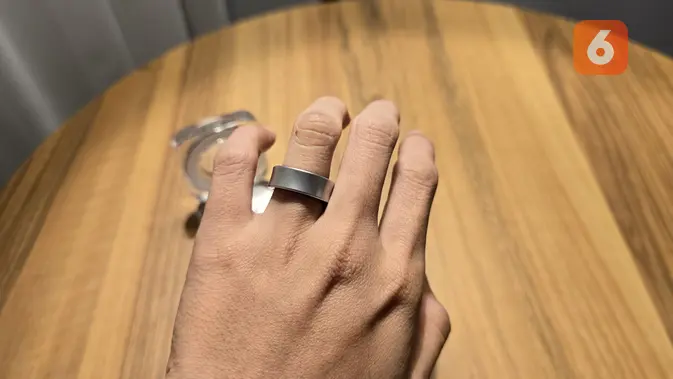 <p>Galaxy Ring ketika dikenakan. Terdapat logo Samsung di dalam Galaxy Ring berikut sensor yang bisa melacak berbagai metrik kesehatan lewat sentuhan sensor dengan kulit jari. (Liputan6.com/ Agustin Setyo Wardani)</p>