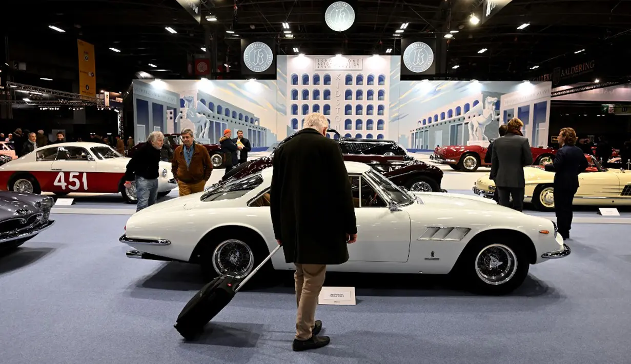 Pengunjung melihat mobil klasik yang dipamerkan pada pameran mobil klasik internasional Retromobile edisi ke-47 di Paris Expo Porte de Versailles, Paris, Prancis, 31 Januari 2023. Retromobile yang berlangsung pada tanggal 1 hingga 5 Februari 2023 menawarkan kesempatan kepada pengunjung untuk menemukan kembali model dan koleksi mobil klasik. (Emmanuel DUNAND/AFP)