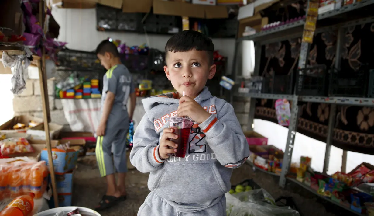 Emad dan kakaknya saat berada kamp pengungsian dekat Kota Duhok, Irak, pada 19 April 2016. Sejumlah anak laki-laki Yazidi dipaksa mengikuti latihan untuk menjadi penerus militan ISIS. (REUTERS / Ahmed Jadallah)