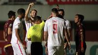 Wasit Hamim Tohari memberikan kartu kuning kepada bek PSM Makassar, Erwin Gutawa, ketika melawan Persija Jakarta pada semifinal Piala Menpora di Stadion Maguwoharjo, Sleman, Kamis (15/4/2021). (Bola.com/Ikhwan Yanuar).