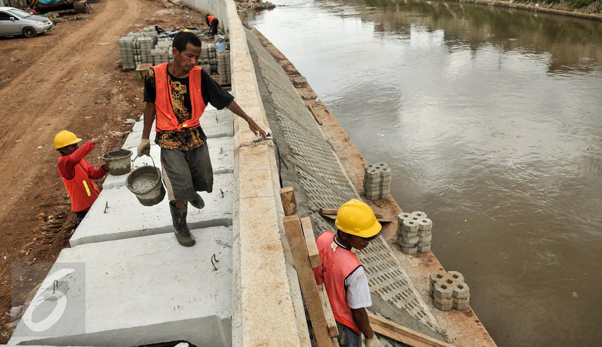 Pekerja menyelesaikan pengerjaan pada dinding parapet di proyek normalisasi Ciliwung, Bukit Duri, Jakarta Selatan, Rabu (8/2). Proyek normalisasi Ciliwung Bukit Duri ditargetkan rampung pada Mei mendatang. (Liputan6.com/Yoppy Renato)