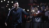 Lionel Messi menyapa penggemar sebelum acara pertandingan perpisahan Maxi Rodriguez sebagai pesepak bola profesional yang diselenggarakan di Marcelo Bielsa Stadium, Argentina, Minggu (25/6/2023). (AFP/Stringer)