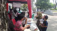 Warga Kota Bekasi antre mendapatkan vaksinasi yang digelar Polres Metro Bekasi Kota di Alun-alun M Hasibuan, Bekasi Selatan. (Foto: Liputan6.com/Bam Sinulingga)