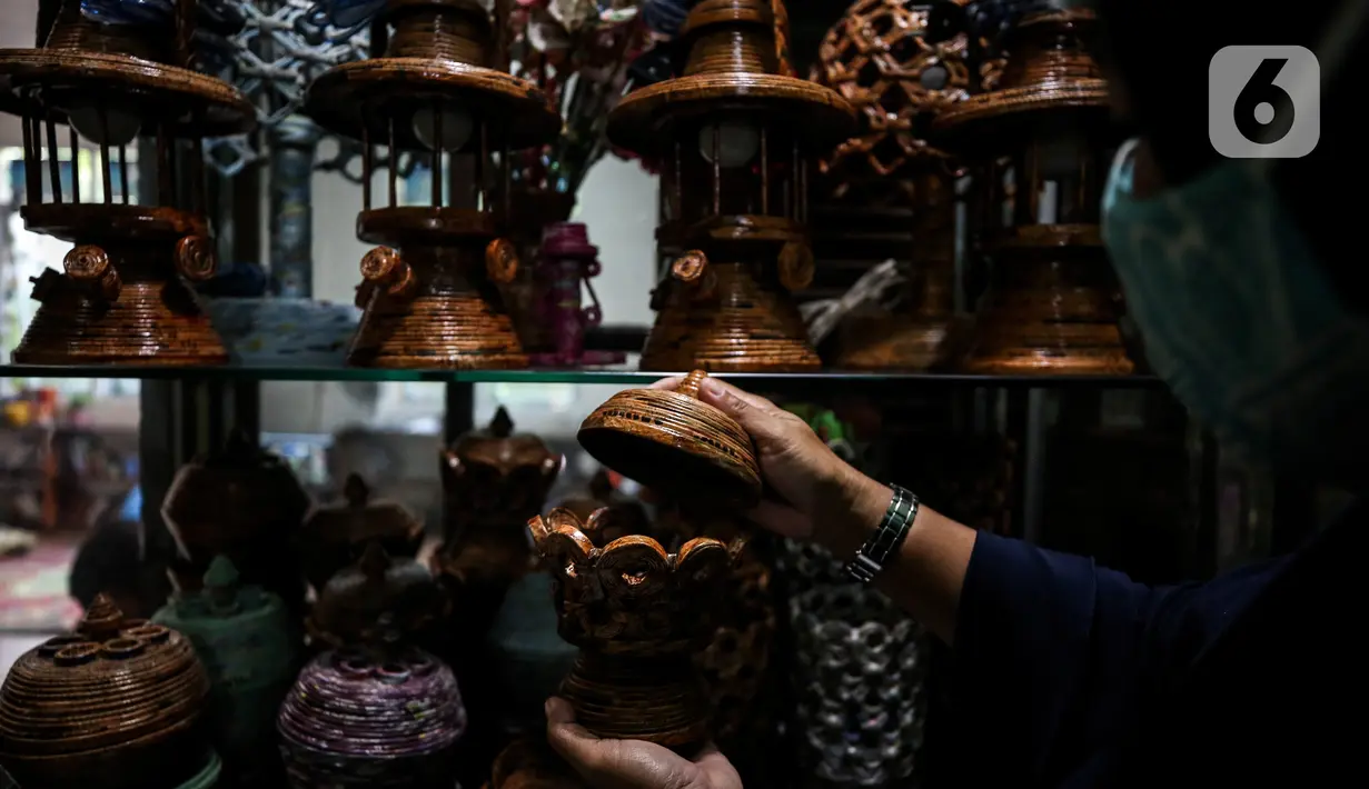 Sugito (68) menyelesaikan pembuatan miniatur Monas dari kertas koran bekas di Bank Sampah Tri Alam Lestari, Jakarta Selatan, Rabu (9/6/2021). Selain miniatur Monas, Sugito juga memanfaatkan kertas bekas untuk membuat berbagai macam barang kerajinan yang bernilai ekonomis. (Liputan6.com/Johan Tallo)