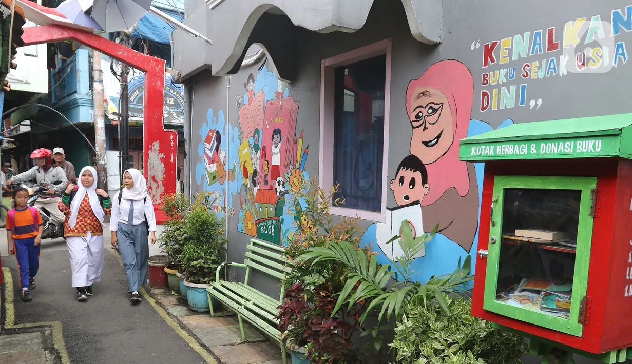 Pelajar melintas di Kampung Literasi RW 08, Jatipulo, Palmerah, Jakarta Barat, Kamis (30/1/2020). Kampung Literasi ini memiliki 5 kotak berisi beragam buku yang ada di sejumlah titik, berbekal konsep kejujuran disebar di sepanjang kampung. (Liputan6.com/Herman Zakharia)