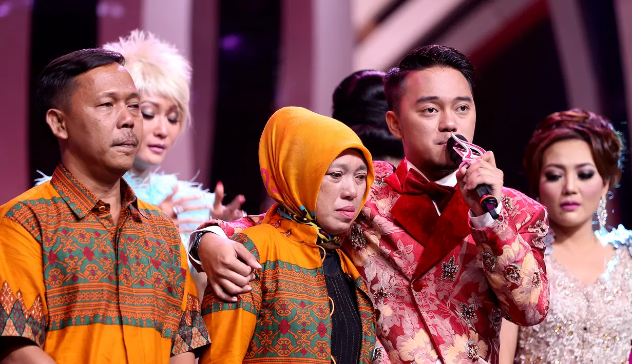 Momen yang sangat berharga untuk Danang, di malam kemenangannya ia ditemani kedua orangtuanya. Danang pun mengucap syukur di atas panggung D'Academy Asia 2015, Jakarta Barat, Rabu (30/12/2015) dini hari. (Andy Masela/Bintang.com)