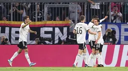 Pemain Jerman Jonas Hofmann, kanan, merayakan dengan rekan setimnya setelah mencetak gol ke gawang Inggris pada pertandingan Grup A3 UEFA Nations League di Allianz Arena, Munich, Rabu (8/6/2022). Inggris bermain imbang dengan Jerman 1-1. (AP Photo/Markus Ulmer)
