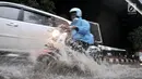 Pengendara sepeda motor menerobos banjir yang menggenangi Jalan DI Panjaitan, Jakarta, Senin (3/12). Banjir juga disebabkan adanya pengerjaan proyek Tol Becakayu yang berada di jalan tersebut. (Merdeka.com/ Iqbal S. Nugroho)