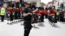 Polisi menjaga Resimen Kerajaan Skotlandia saat berbaris di jalan raya memperingati kelahiran anak pertama Pangeran Harry dan Meghan Markle di Windsor, Inggris, Selasa (7/5/2019). Pangeran Harry menyatakan bahwa dia dan Meghan Markle masih memikirkan nama anak mereka. (AP Photo/Alastair Grant)
