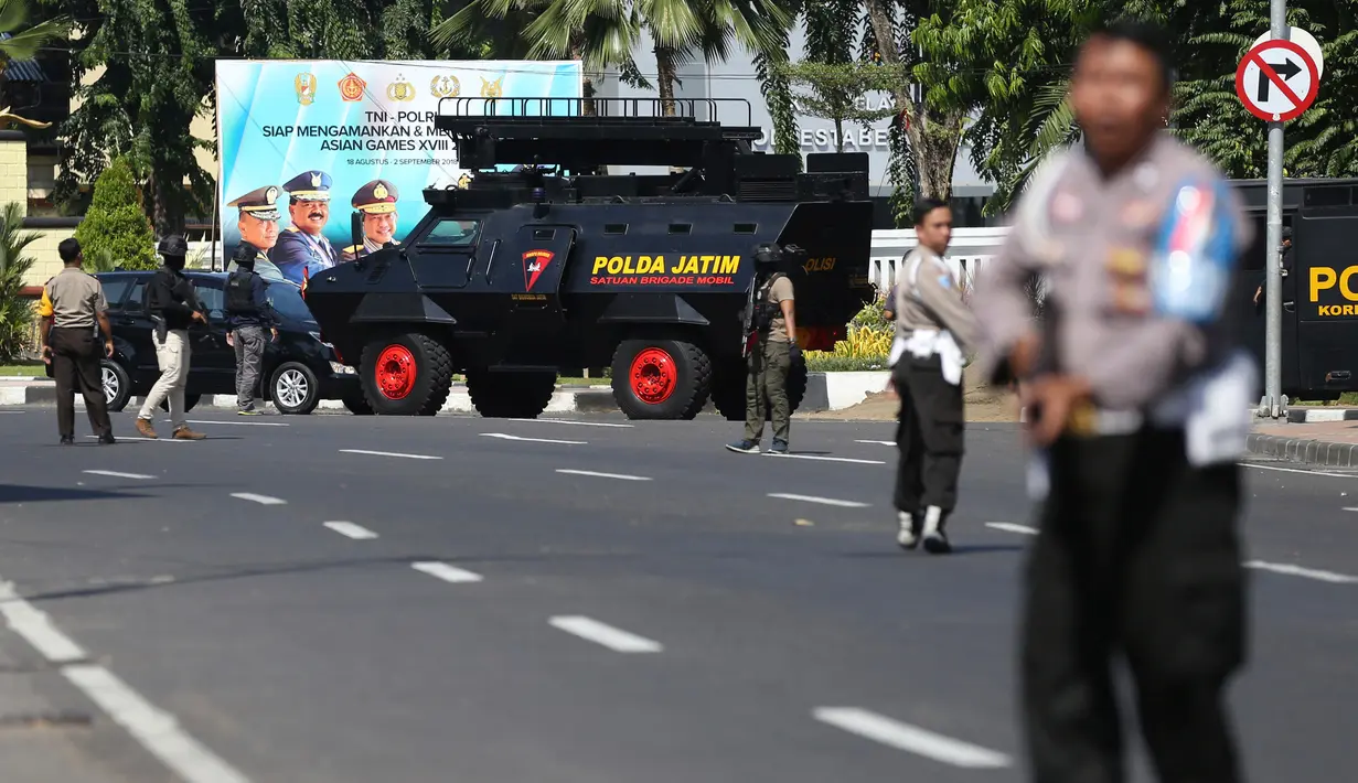 Aparat kepolisian menutup jalan setelah serangan bom bunuh diri di Polrestabes Surabaya, Jawa Timur, Senin (14/5). Seluruh akses menuju Mapolrestabes ditutup total dan tiap jalur dijaga petugas kepolisian bersenjata laras panjang. (AP/Achmad Ibrahim)