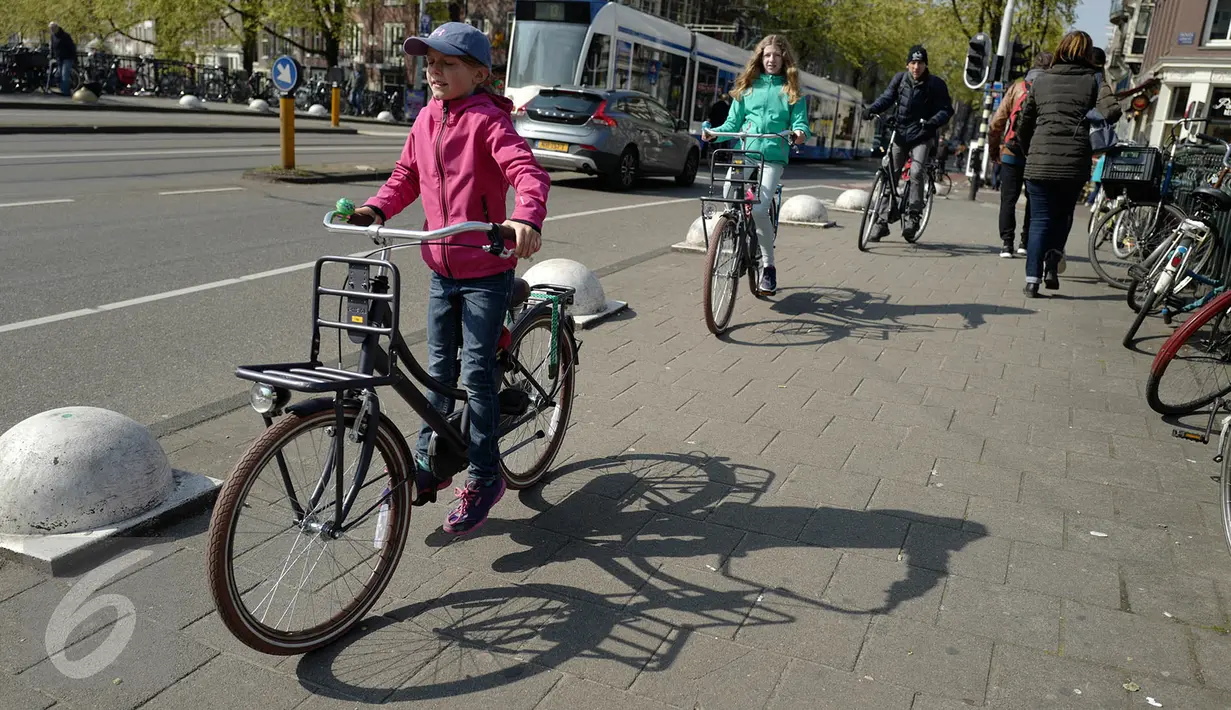 Seorang anak mengendarai sepeda di sekitar kawasan kota Amsterdam, Belanda, Kamis (20/4). Seluruh lapisan masyarakat, tua muda memilih menggunakan transportasi sepeda untuk bepergian. (Liputan6.com/Immanuel Antonius)