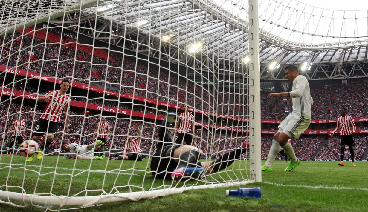 Gelandang Real Madrid, Casemiro, menjebol gawang Athletic Bilbao. Dua gol Madrid disarangkan Karim Benzema pada menit ke-25 dan Casemiro menit ke-68. Sementara, gol Athletic Bilbao dicetak oleh Aritz Aduriz menit ke-65. (EPA/Luis Tejido)